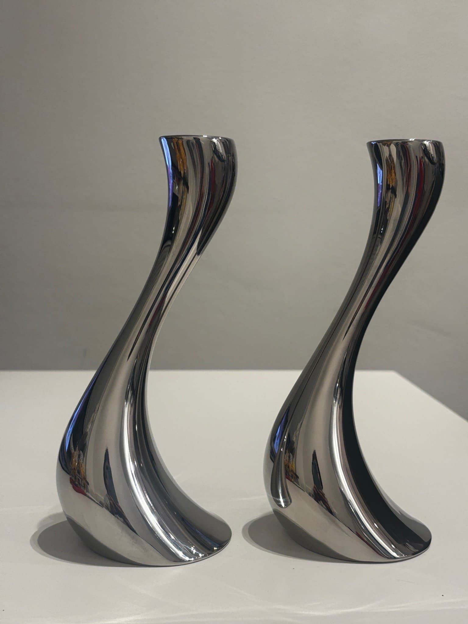 CONSTANTIN WORTMANN. A pair of 2 “Cobra” candlesticks, Georg Jensen, Denmark.