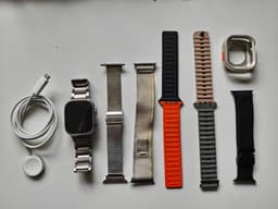 Apple Watch Ultra Titanium 49mm with multiple straps and accessories